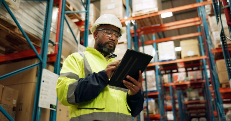 Warehouse, black man and manufacturing with tablet, inventory and checklist in a factory. African person, worker and employee with tech and inspection with digital app for logistics and online stock.